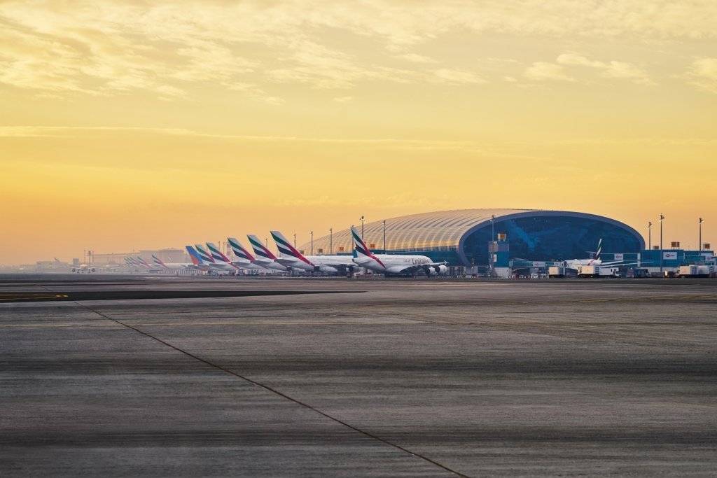 Aerial view of Dubai International Airport with busy terminals in 2025