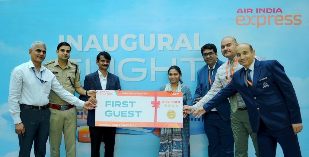 Dignitaries and the Air India Express team present ceremonial boarding passes to the first guests from Bhopal