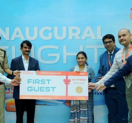 Dignitaries and the Air India Express team present ceremonial boarding passes to the first guests from Bhopal